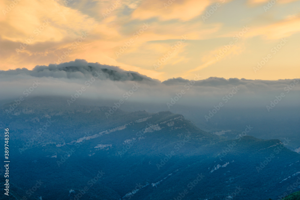 Obraz premium Sunrise in the mountains (the Peak of Comanegra covered with fog - Alta Garrotxa, Catalonia, Spain)