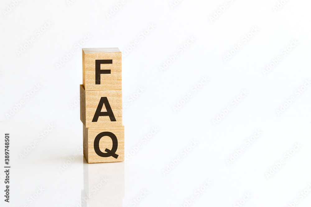 Three wooden cubes with letters FAQ - Frequently Asked Question, on white table, more in background, space for text in right down corner Three wooden cubes with letters FAQ - Frequently Asked Question, on white table, more in background, space for text in right down corner