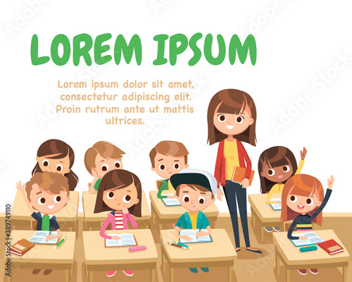 Teacher with pupils in a classroom stand in aisle. Primary school kids. Pupils raising hands. Teacher taking class. Back to school. Primary school kids.