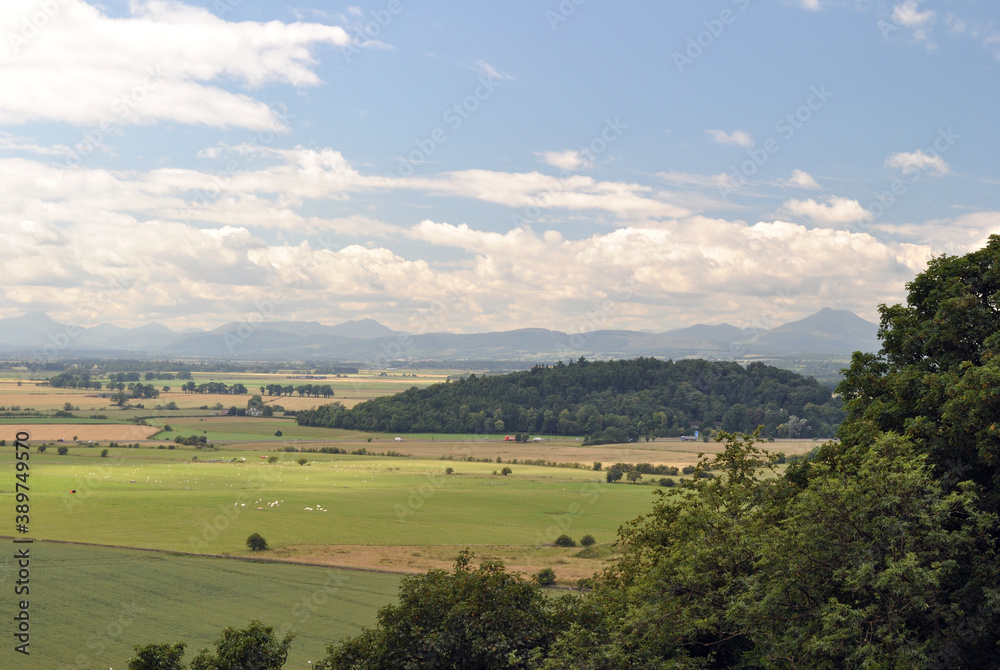 Hazy Summer View of Landscape with Hills & Woodland under Blue Sky Hazy Summer View of Landscape with Hills & Woodland under Blue Sky