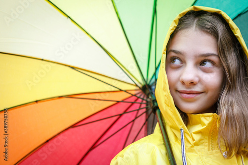 beautiful teenager girl wearing yellow raincoat