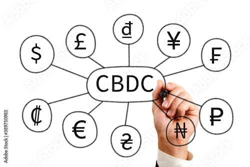 cbdc. a man draws the inscription cbdc and icons of currencies of different states photo