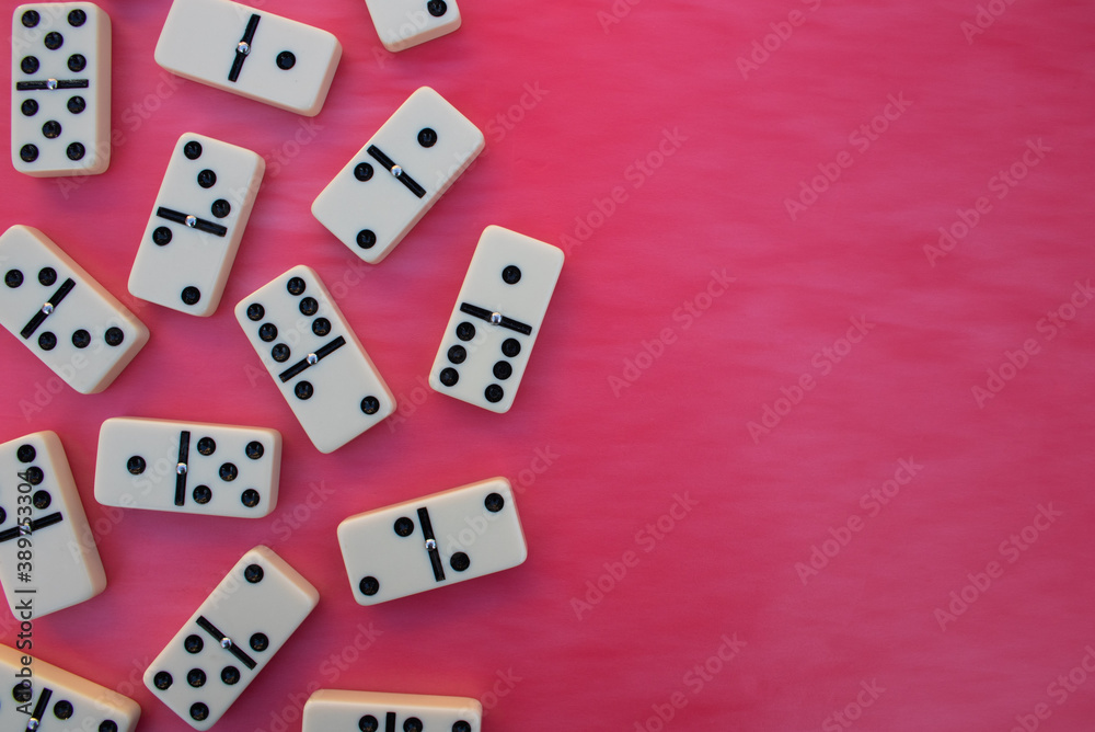 Deck of scattered dominoes on vibrant red background. Top down view flat lay with empty space for text Deck of scattered dominoes on vibrant red background. Top down view flat lay with empty space for text