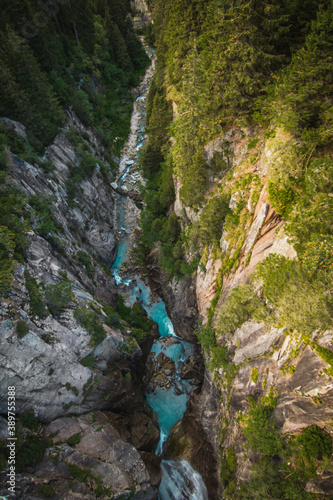 view from above to valley with blue river in Switzerland