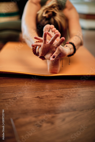 Middle aged yogi woman doing yoga at home.