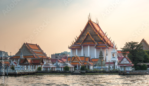 Wat Kanlayanamit in Bangkok, Thailand as Seen from the Boat Cruising the Chao Phraya River