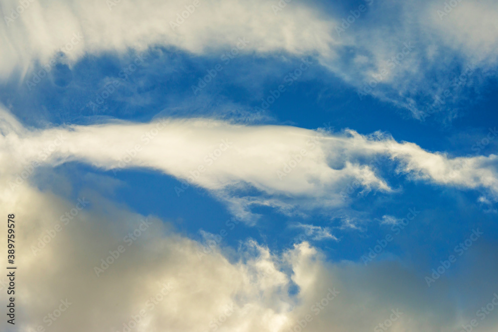 Fototapeta premium Clouds in a blue sky in bright sunlight in autumn, Almere, Flevoland, The Netherlands, November 2, 2020