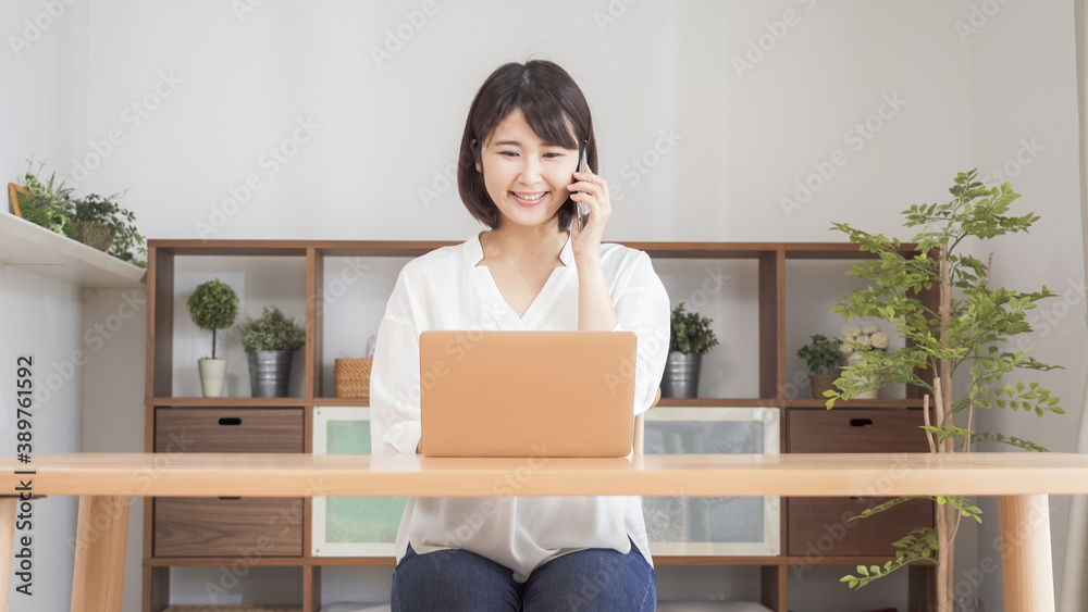 リビングでパソコンをする女性 リビングでパソコンをする女性