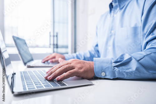 man works using two laptop in the same time