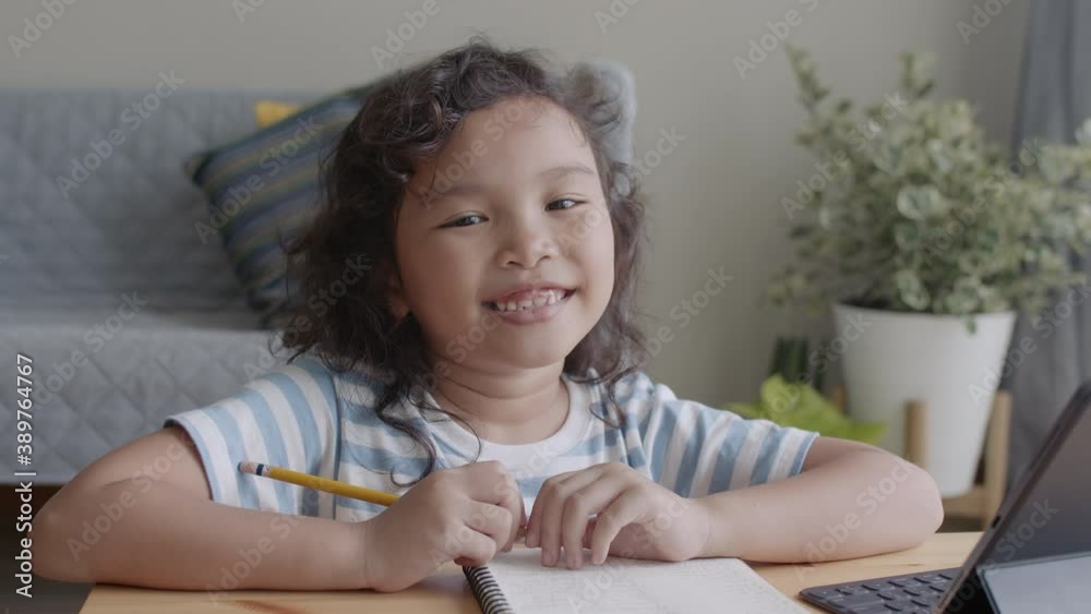 Medium close up. Portrait Asian little girl happy smiling expression on the face at home her Medium close up. Portrait Asian little girl happy smiling expression on the face at home her