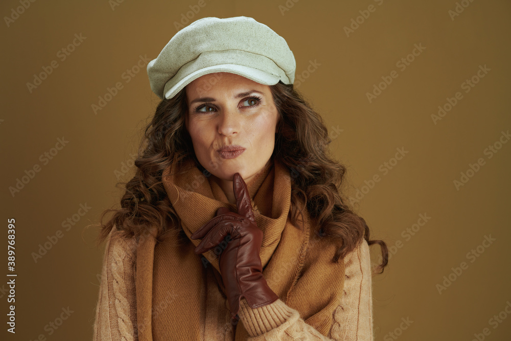 Portrait of pensive modern woman in sweater isolated on beige Portrait of pensive modern woman in sweater isolated on beige