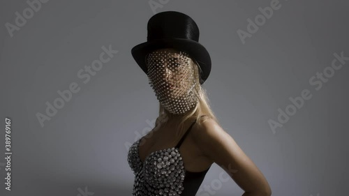 Young woman wearing top hat with sparkly veil and bustier photo