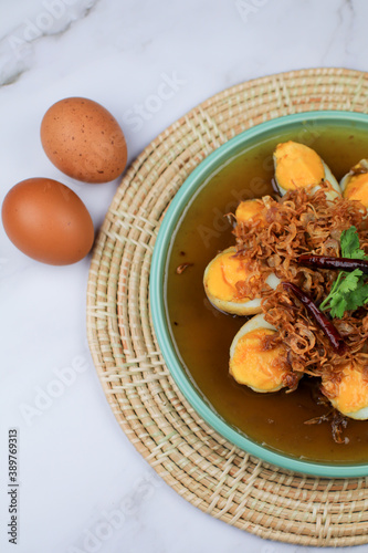 Fried egg with tamarind sauce or Sweet and Sour Eggs topped with fried onions and dried chilies. Thai food / Select focus