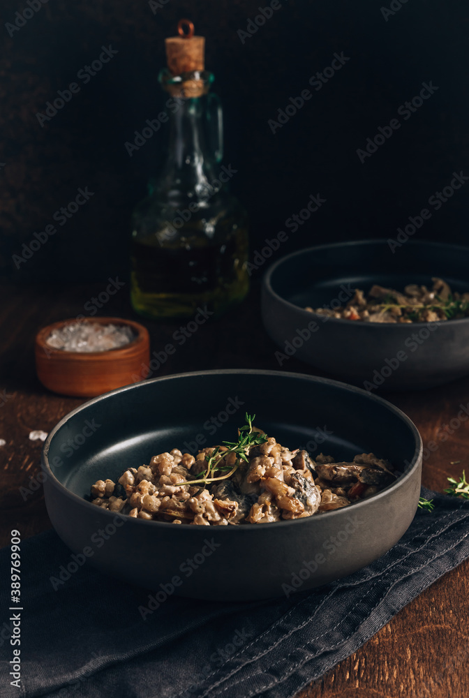 Homemade creamy vegan risotto or orzotto with barley, mushrooms and coconut milk Homemade creamy vegan risotto or orzotto with barley, mushrooms and coconut milk