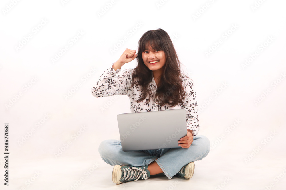 Portrait of an excited young beautiful girl holding laptop computer and celebrating success isolated over white background. Portrait of an excited young beautiful girl holding laptop computer and celebrating success isolated over white background.