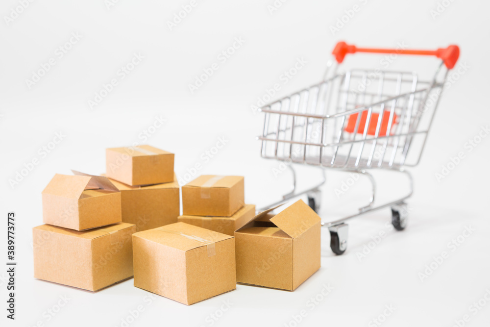 Many parcel boxes and a shopping cart on white background for  online shopping concept