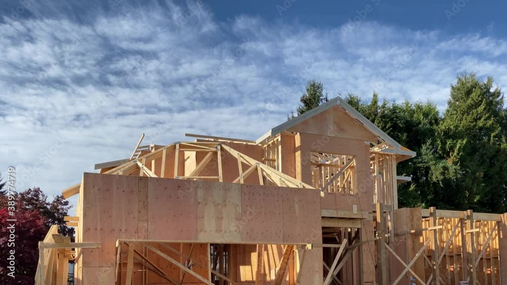House under construction. The site with wooden frame. Still camera view. House under construction. The site with wooden frame. Still camera view.