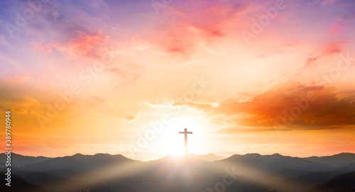 Good Friday concept: Silhouette cross on mountain sunset background