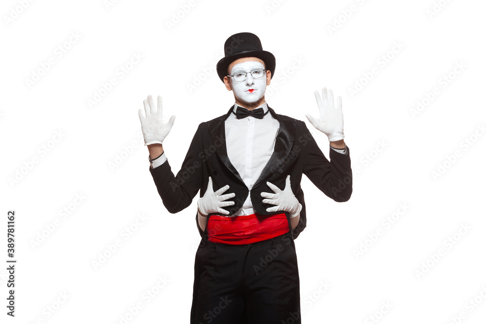 Portrait of two mime artists performing, isolated on white background. Mime hid behind his friend, holding his waist Portrait of two mime artists performing, isolated on white background. Mime hid behind his friend, holding his waist