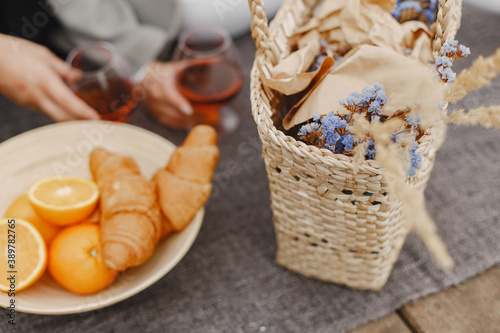 People by the river. Delicious healthy summer picnic on the grass. Fruits on a blancet. photo