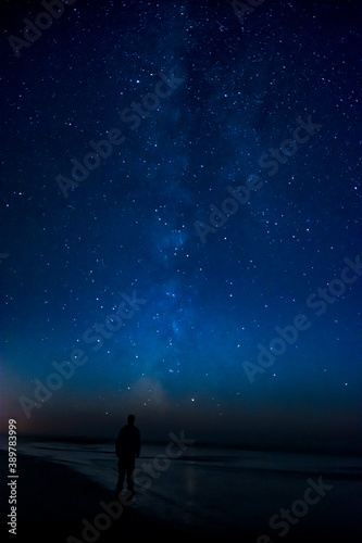 Adventurous man watching the stars on a beach at night.  © Pelo Blanco Photo