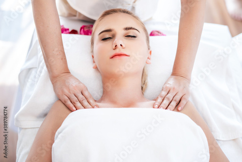 Beautiful young attractive Caucasian woman having body massage by Thai Masseur in spa salon. Beauty treatment and body care lifestyle concept
