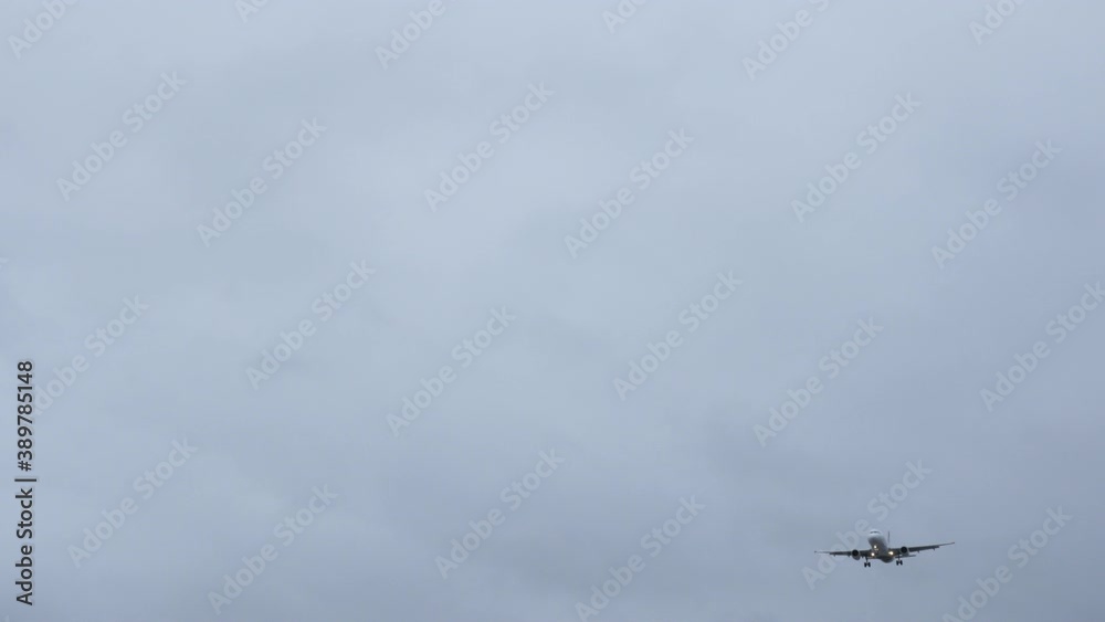 Jumbo Jet Plane coming into land in gray/stormy weather shot in 4k high resolution Jumbo Jet Plane coming into land in gray/stormy weather shot in 4k high resolution