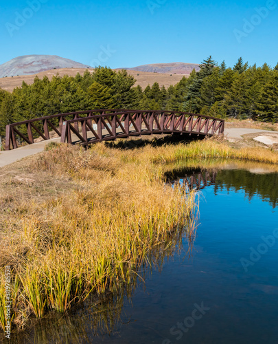Bridge On Andrews Lake With The San Juan Mountains, Andrews Lake State Wildlife Area, Colorado, USA