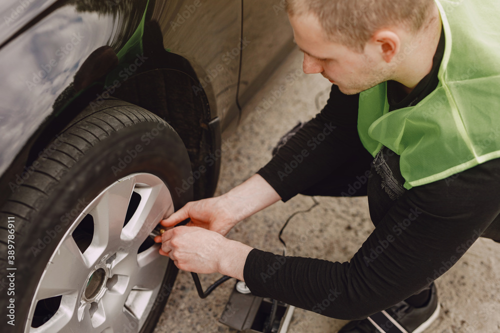 Man changing wheel after a car breakdown. Transportation, traveling concept. Man changing wheel after a car breakdown. Transportation, traveling concept.