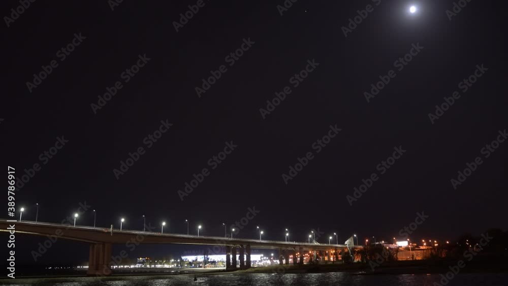night. road bridge over the river with lights and moving cars. night. road bridge over the river with lights and moving cars.
