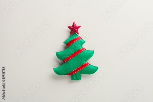 handmade creative fir tree and red star and ribbons on white background, Merry Christmas and Happy Hew composition, top view, copy space, flat lay