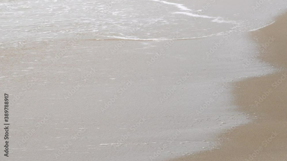 The gentle wave is hit the sandy beach. The gentle wave is hit the sandy beach.