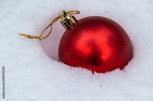 beautiful Christmas fur-tree toys in the snow with the structure in the Christmas and New year