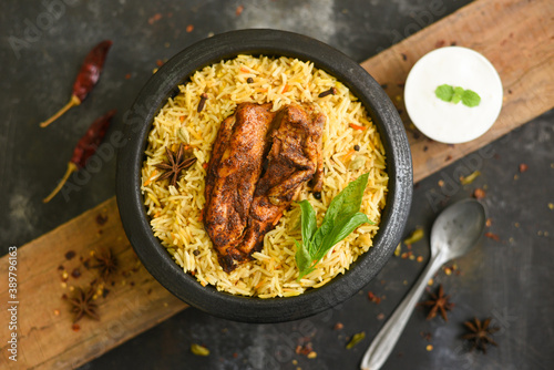 Arabic chicken Manthi or mandi cooked meat, Basmati rice with Masala, spice. Kuzhimanthi or hot and spicy Manthi on black background in Malabar Kerala, South India. Top view of Indian non veg food. photo