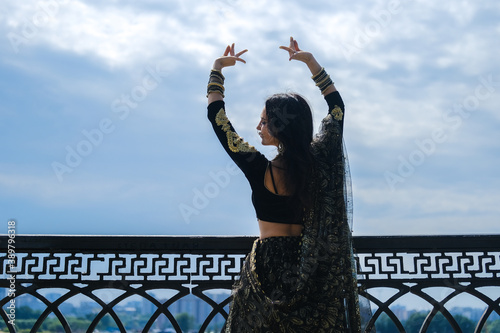 Woman in ethnic indian costume with gold jewellery and traditional makeup.