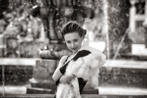 Retro portrait of a young fashionable woman in the city .Black and white image