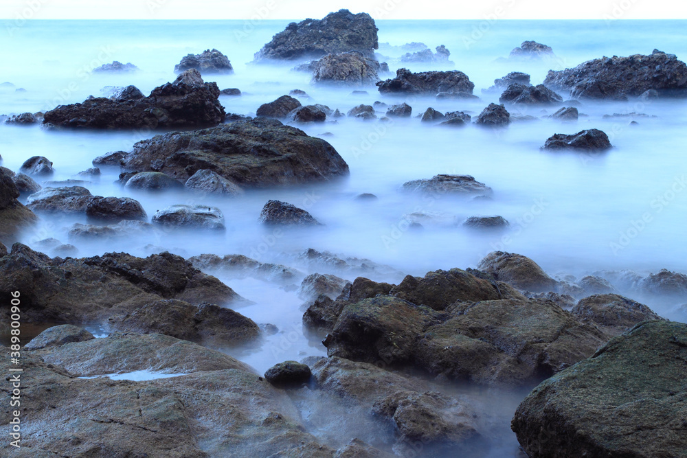 Long exposure capture of rocks, stones, and waves at Pintu Kota beach, Ambon island, Indonesia