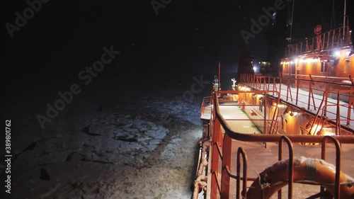 View on deck of Nuclear Icebreaker sail in the night. Snowfall