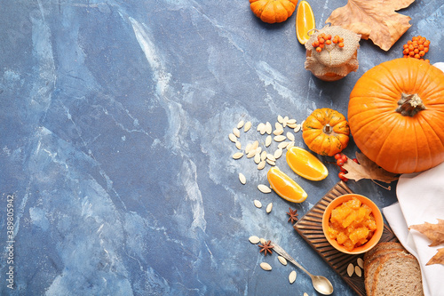 Autumn composition with tasty pumpkin jam on color background
