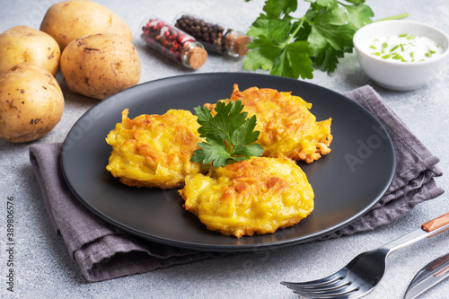 Fried cakes of grated potatoes on the plate with sauce. Traditional pancakes boxty raggmunk.