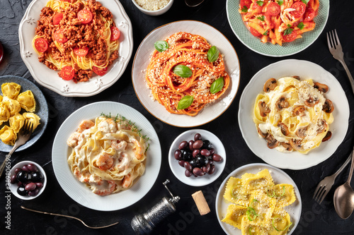 Pasta, many different varieties, shot from the top on a black background, Italian food flat lay