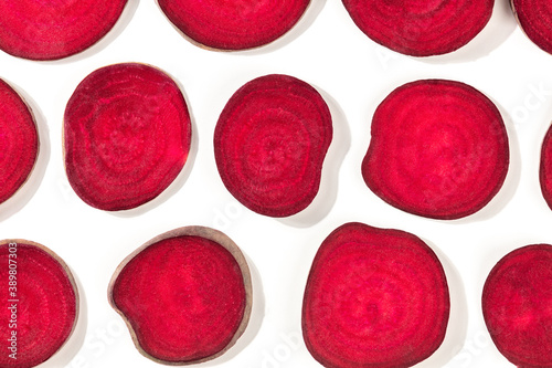 Beet pattern, vibrant red slices, shot from above on a white background, a flat lay, vegan food banner