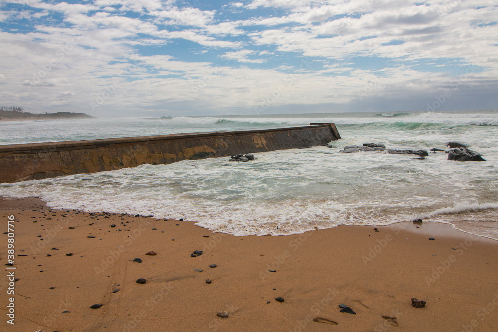 Cement Jetty Leading from Shoreline into Rough Sea