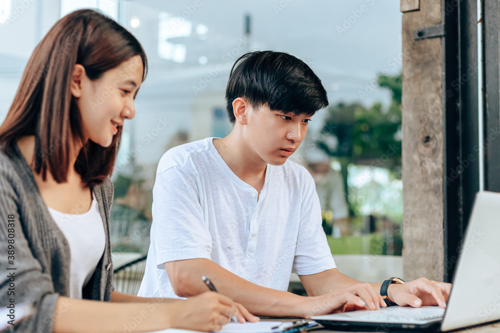 High school or college students group catching up workbook and learning tutoring on desk and reading, doing homework, lesson practice preparing exam. High school or college students group catching up workbook and learning tutoring on desk and reading, doing homework, lesson practice preparing exam.