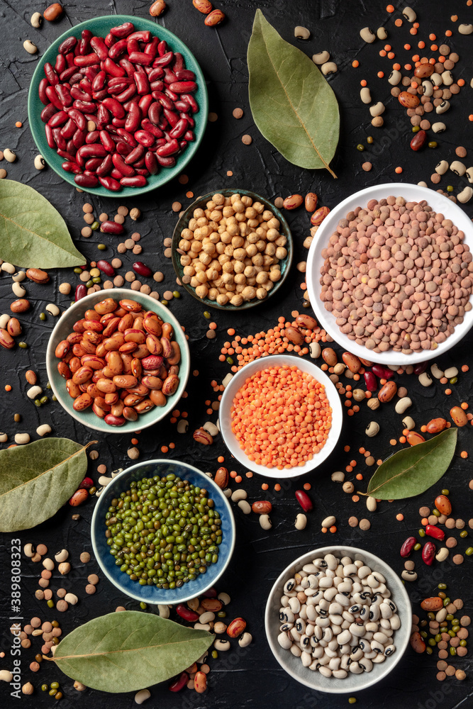 Various legumes, shot from the top on a dark background. Lentils, soybeans, chickpeas, red kidney beans, black-eyed peas and other pulses, a flat lay Various legumes, shot from the top on a dark background. Lentils, soybeans, chickpeas, red kidney beans, black-eyed peas and other pulses, a flat lay