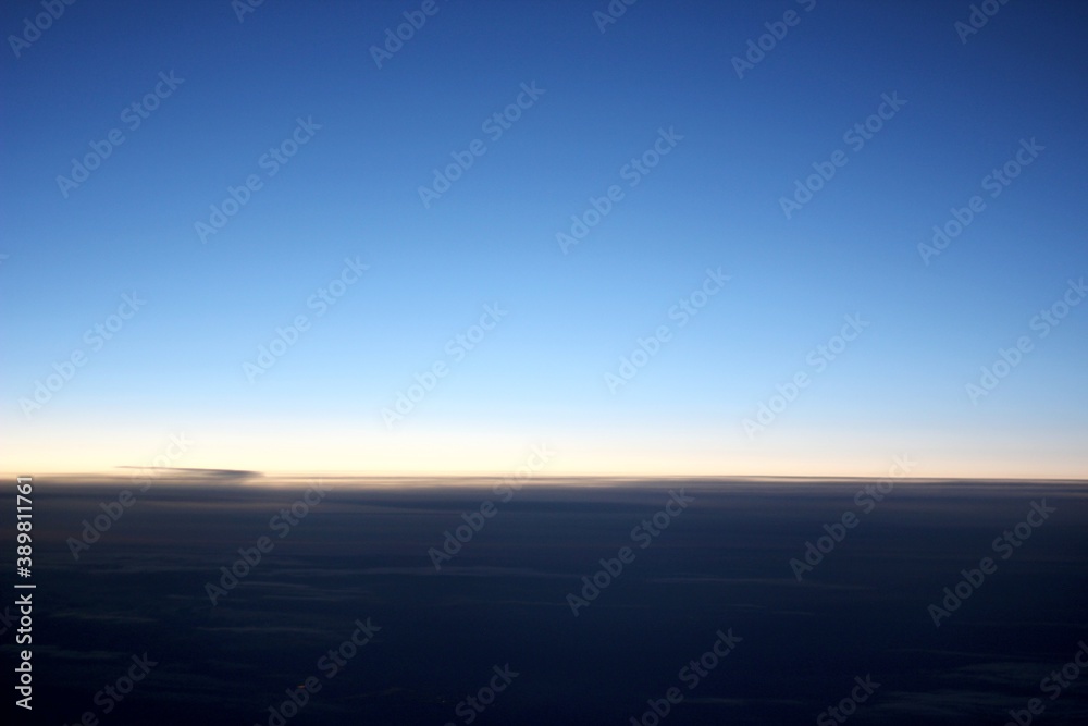 Obraz premium blue sky above clouds from the plane window