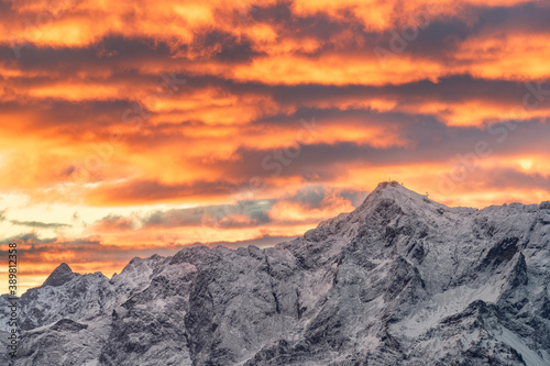 Sunrise at mountain zugspitze in winter with snow and colorful sky. Highest german mountain. Cable car. Germany austria