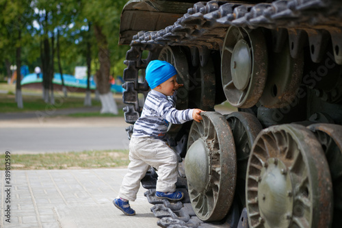 little child playing near military military equipment © makam1969