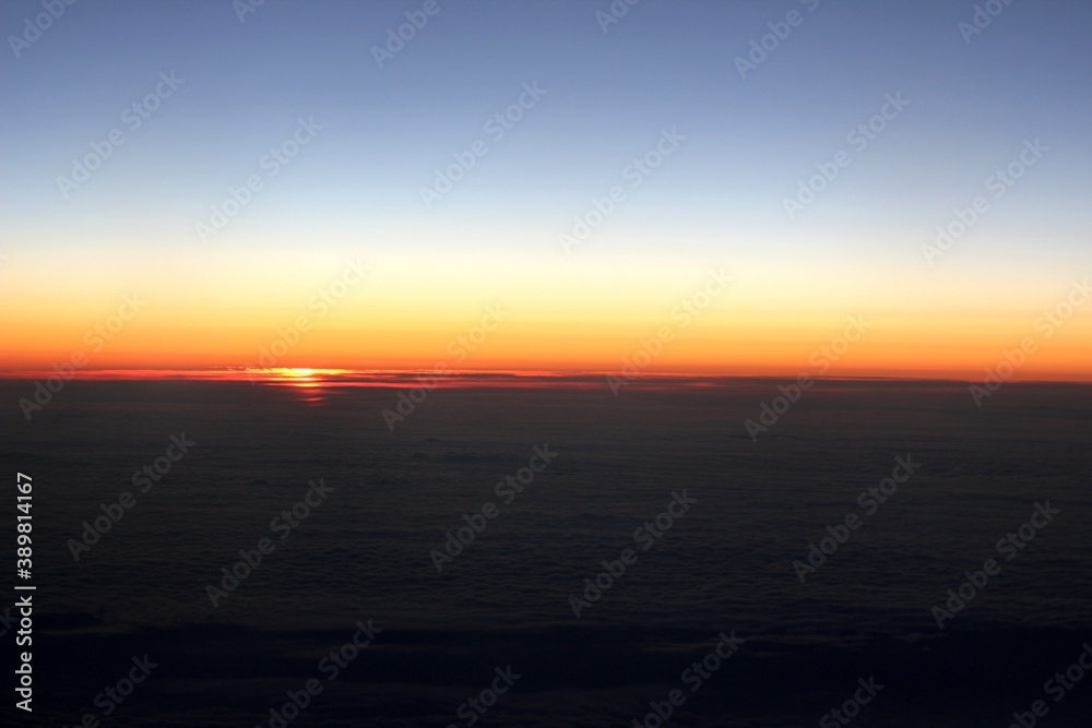 sunrise above the clouds from the plane window
