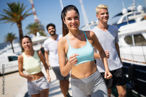 Friends running fitness training together outdoors living active healthy